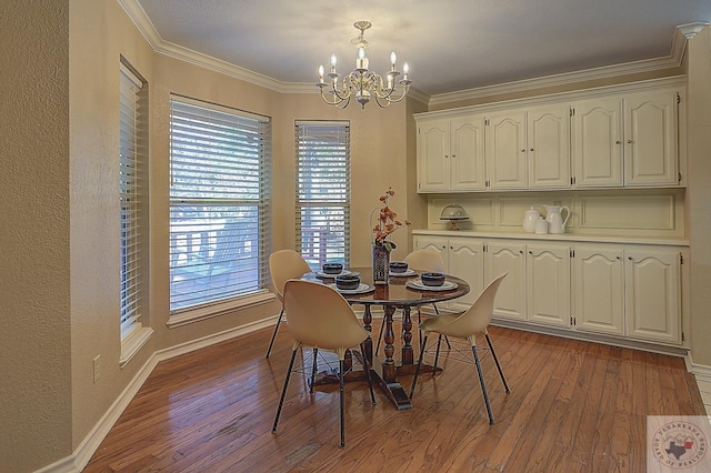 dining space with a healthy amount of sunlight, hardwood / wood-style floors, an inviting chandelier, and crown molding