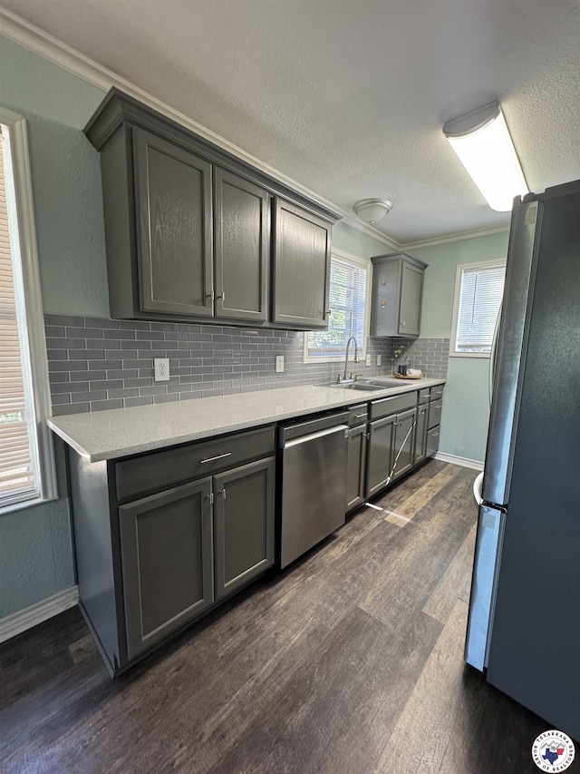 432 Carrol Ave, Wake Village, TX 75501 - kitchen featuring stainless steel appliances, gray cabinetry, dark wood-style flooring, decorative backsplash, and crown molding