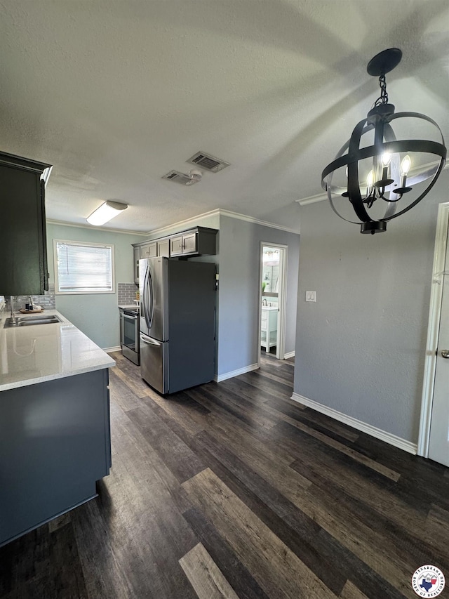 432 Carrol Ave, Wake Village, TX 75501 - kitchen featuring stainless steel appliances, dark wood finished floors, light countertops, crown molding, and a chandelier