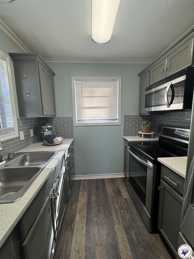 432 Carrol Ave, Wake Village, TX 75501 - kitchen with stainless steel appliances, gray cabinetry, healthy amount of natural light, crown molding, and a textured ceiling