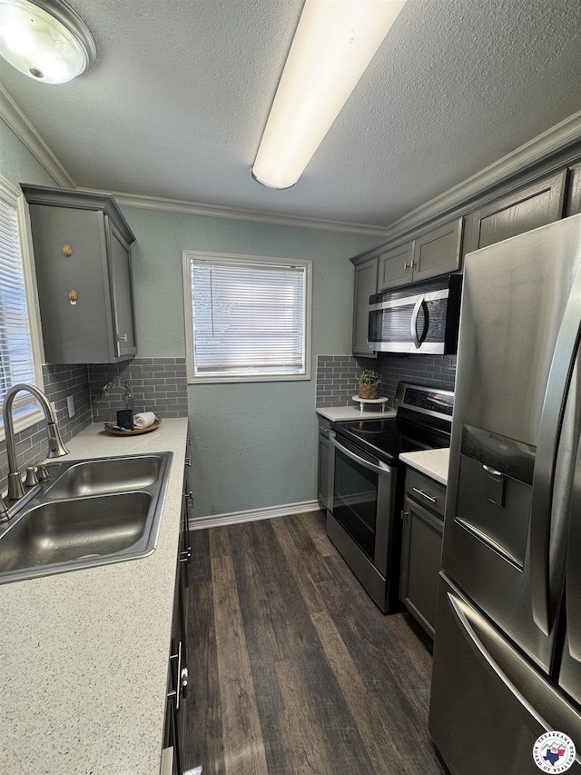 432 Carrol Ave, Wake Village, TX 75501 - kitchen with appliances with stainless steel finishes, light countertops, crown molding, backsplash, and gray cabinets