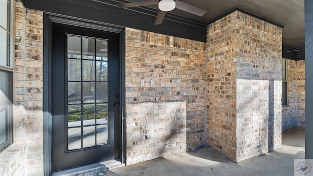 view of exterior entry featuring a ceiling fan