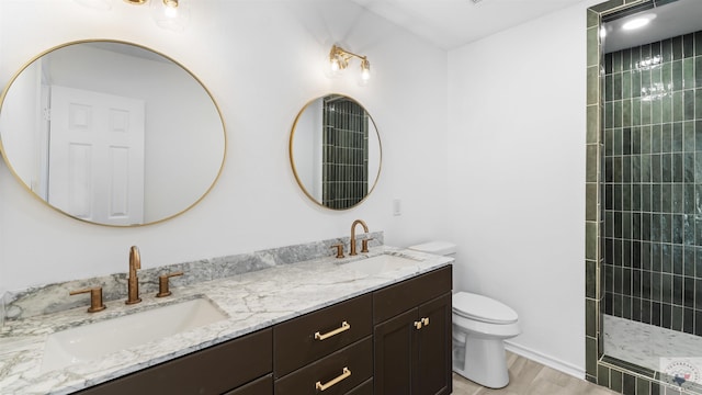 full bath featuring toilet, double vanity, a walk in shower, and a sink