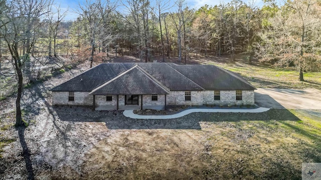 view of front of house featuring stone siding and a front lawn