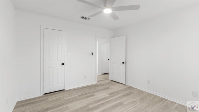 unfurnished bedroom with light wood-style flooring, visible vents, ceiling fan, and baseboards