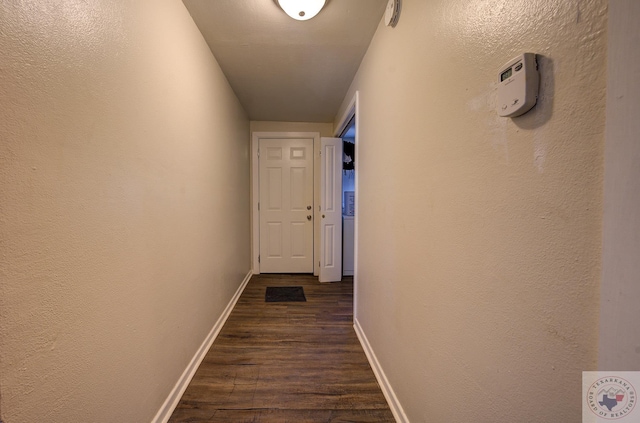 hallway with dark hardwood / wood-style floors