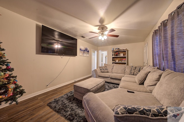 living room featuring ceiling fan and dark wood-type flooring