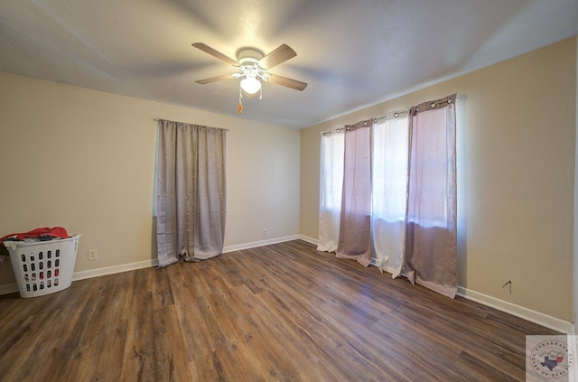 empty room featuring ceiling fan and dark wood-type flooring