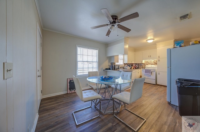 dining area with hardwood / wood-style flooring, ornamental molding, and ceiling fan