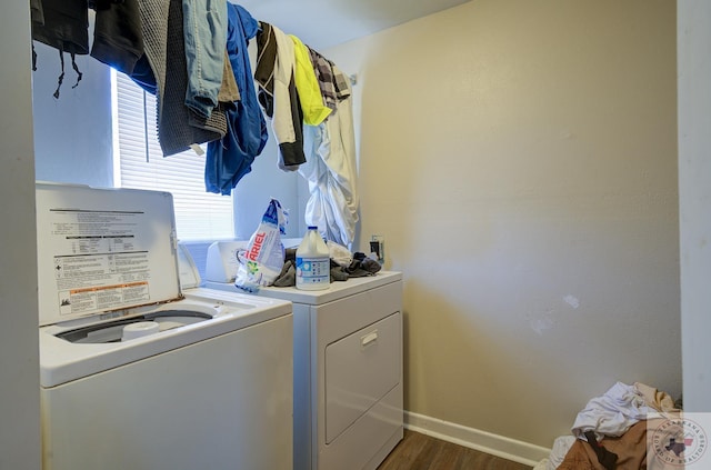 washroom with dark hardwood / wood-style flooring and washing machine and clothes dryer