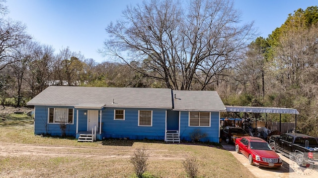 view of front of house with a carport and a front lawn