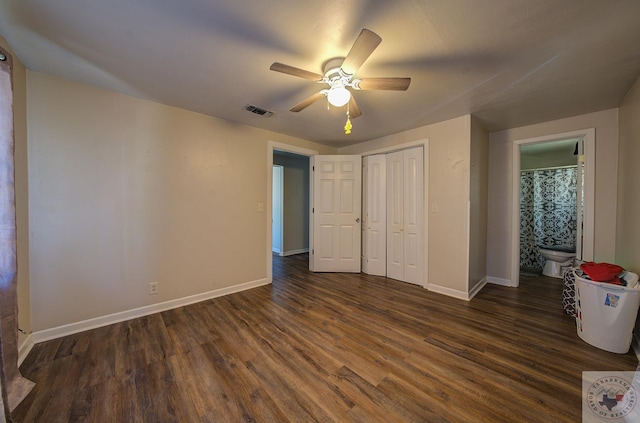 unfurnished bedroom featuring a closet, ceiling fan, dark hardwood / wood-style floors, and ensuite bath