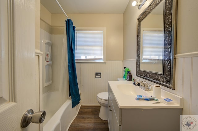 full bathroom with wood-type flooring, shower / bath combo with shower curtain, toilet, and vanity