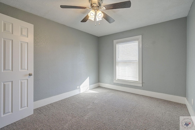 spare room featuring ceiling fan, carpet flooring, and a textured ceiling