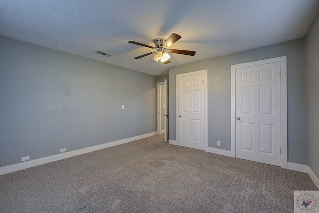 unfurnished bedroom featuring ceiling fan and carpet