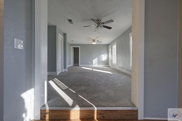 interior space featuring a textured ceiling and carpet