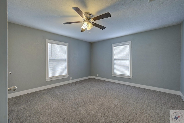 empty room with ceiling fan, a textured ceiling, and carpet