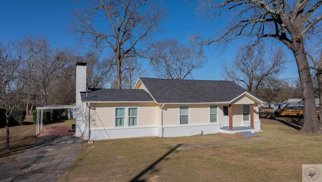 view of side of home with a carport and a lawn