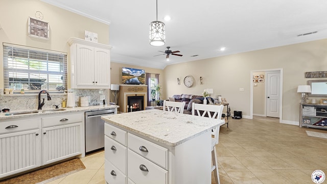 908 Arnold Ln, Texarkana, TX 75503 - kitchen featuring stainless steel dishwasher, ornamental molding, ceiling fan, backsplash, and a center island