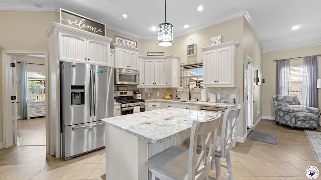 908 Arnold Ln, Texarkana, TX 75503 - kitchen with appliances with stainless steel finishes, crown molding, light tile patterned floors, plenty of natural light, and recessed lighting