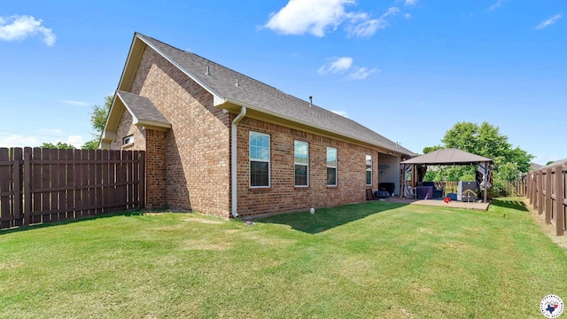 908 Arnold Ln, Texarkana, TX 75503 - rear view of house featuring a gazebo, brick siding, a patio area, a fenced backyard, and roof with shingles