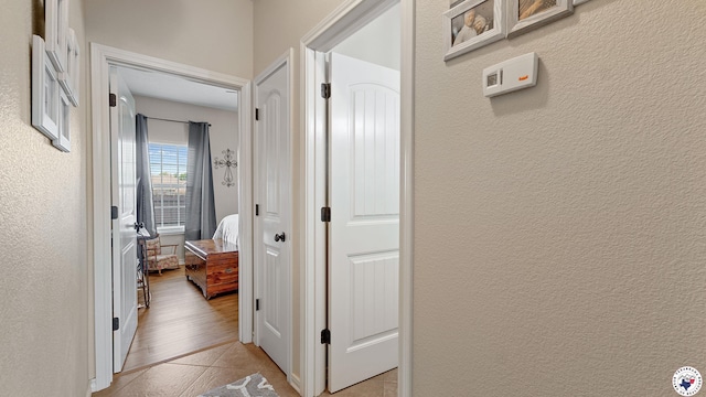 908 Arnold Ln, Texarkana, TX 75503 - corridor featuring light tile patterned floors and a textured wall