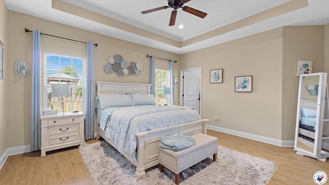 908 Arnold Ln, Texarkana, TX 75503 - bedroom featuring crown molding, a tray ceiling, light wood-style flooring, recessed lighting, and a ceiling fan