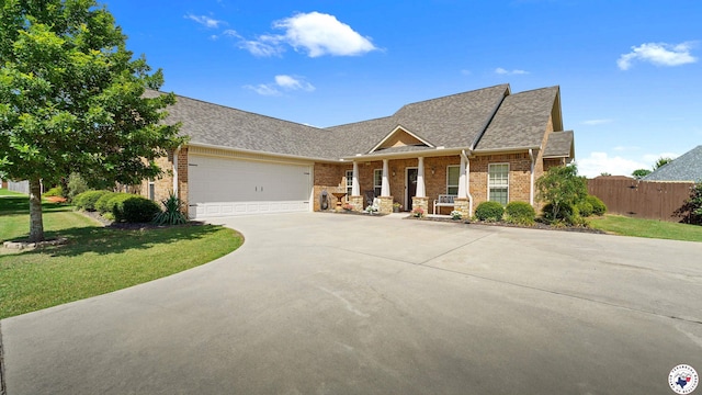 908 Arnold Ln, Texarkana, TX 75503 - view of front of property with brick siding, concrete driveway, an attached garage, roof with shingles, and covered porch