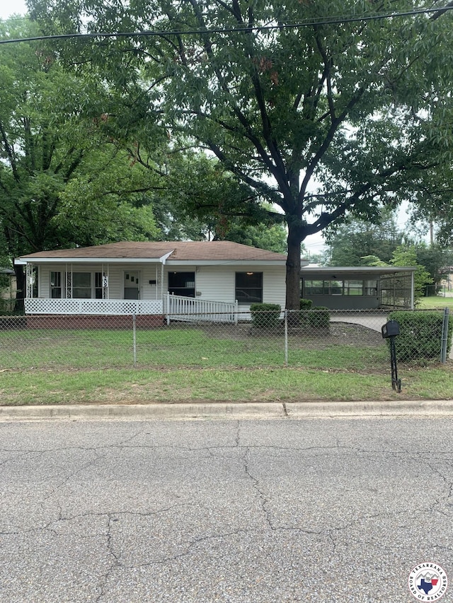 209 E 35th St, Texarkana, AR 71854 - ranch-style home featuring a fenced front yard, covered porch, and a carport