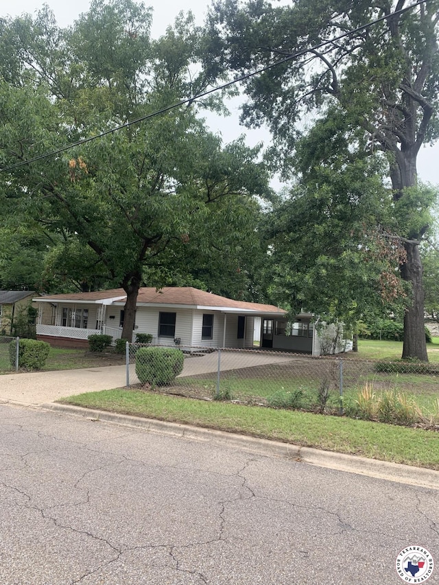 209 E 35th St, Texarkana, AR 71854 - single story home featuring concrete driveway, a fenced front yard, and an attached carport