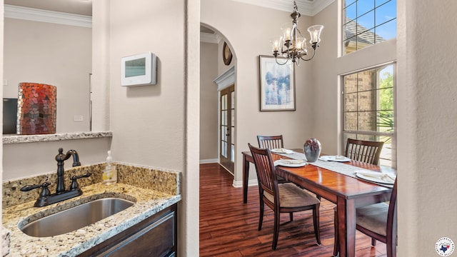 6 Stonewall Cir, Texarkana, TX 75503 - dining space featuring crown molding, dark wood-style floors, arched walkways, and a chandelier