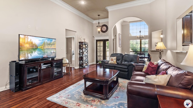6 Stonewall Cir, Texarkana, TX 75503 - living area featuring a towering ceiling, arched walkways, dark wood finished floors, ornamental molding, and a chandelier
