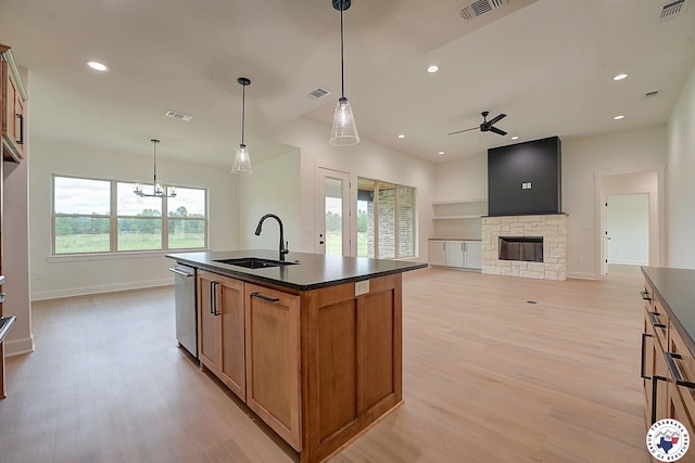101 Ranch Rd, Texarkana, TX 75503 - kitchen featuring a sink, dark countertops, light wood finished floors, brown cabinets, and recessed lighting