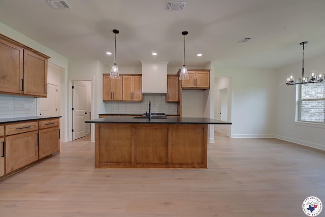101 Ranch Rd, Texarkana, TX 75503 - kitchen featuring dark countertops, a sink, tasteful backsplash, baseboards, and light wood-type flooring
