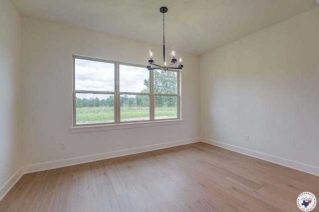 101 Ranch Rd, Texarkana, TX 75503 - unfurnished room featuring a chandelier, light wood-style floors, and baseboards