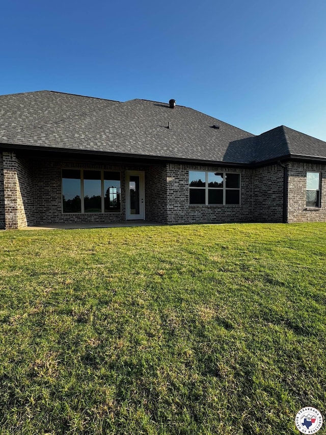 101 Ranch Rd, Texarkana, TX 75503 - rear view of property with brick siding, a yard, and a shingled roof