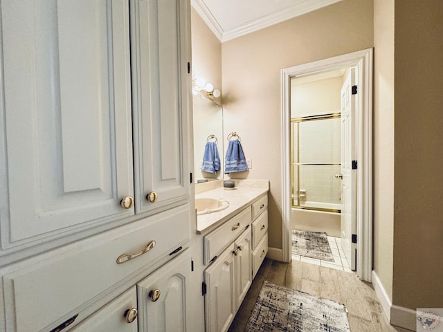 4604 Suzanne Dr, Texarkana, TX 75503 - full bathroom featuring enclosed tub / shower combo, wood finished floors, crown molding, baseboards, and vanity