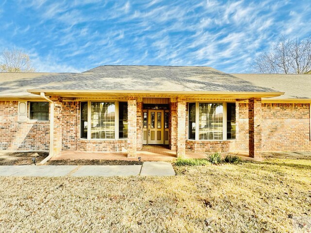 4604 Suzanne Dr, Texarkana, TX 75503 - entrance to property featuring french doors, brick siding, and a shingled roof