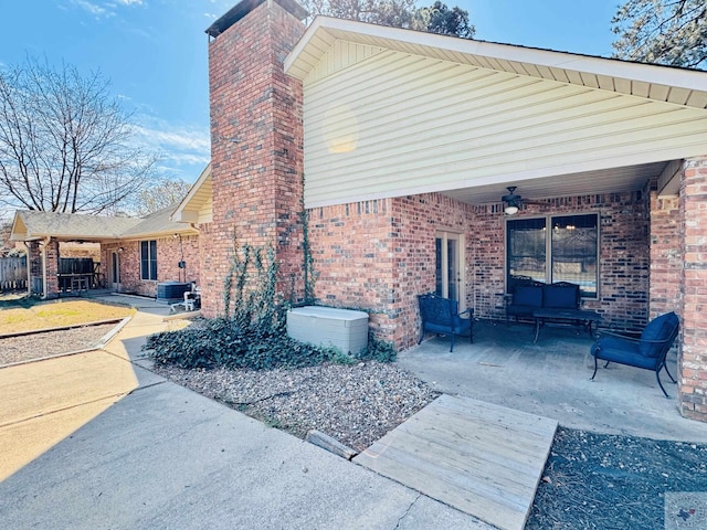 4604 Suzanne Dr, Texarkana, TX 75503 - view of property exterior featuring brick siding, a patio area, a chimney, and ceiling fan