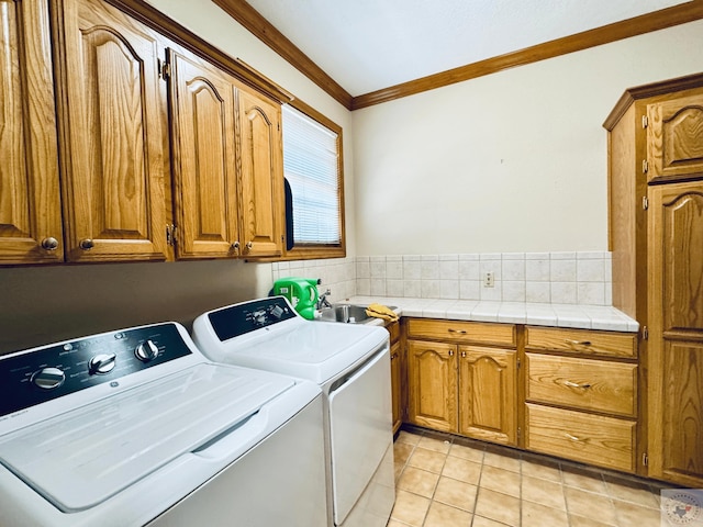 4604 Suzanne Dr, Texarkana, TX 75503 - washroom featuring light tile patterned flooring, cabinet space, washer and dryer, and ornamental molding
