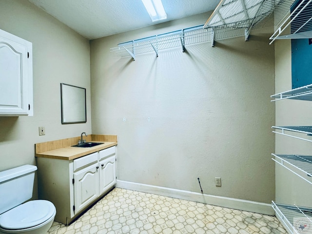 4604 Suzanne Dr, Texarkana, TX 75503 - bathroom with tile patterned floors, toilet, a textured ceiling, baseboards, and vanity