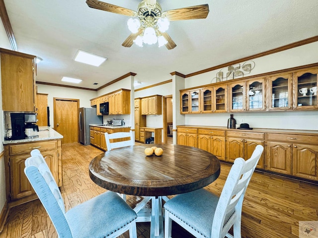 4604 Suzanne Dr, Texarkana, TX 75503 - dining area with a textured ceiling, crown molding, a ceiling fan, and light wood finished floors