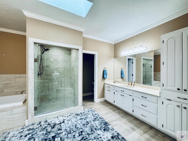 4604 Suzanne Dr, Texarkana, TX 75503 - full bath with a stall shower, ornamental molding, wood finished floors, a skylight, and vanity