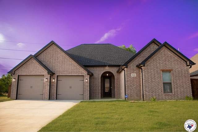 5616 Deaton Pl, Texarkana, TX 75503 - french provincial home with concrete driveway, a garage, brick siding, and a front yard