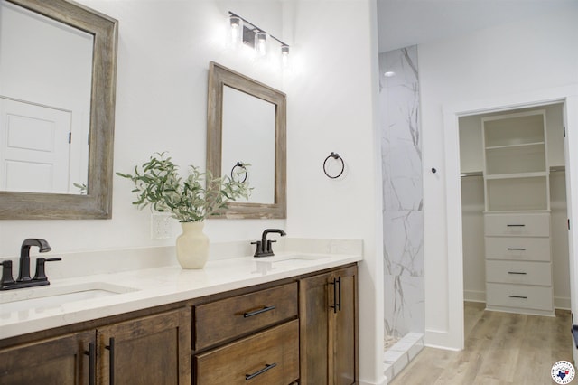 5616 Deaton Pl, Texarkana, TX 75503 - full bathroom featuring double vanity, a marble finish shower, wood finished floors, and a walk in closet
