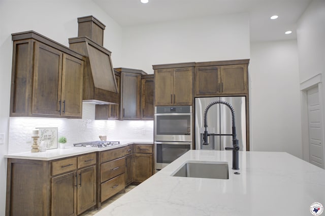 5616 Deaton Pl, Texarkana, TX 75503 - kitchen featuring stainless steel appliances, a sink, light stone counters, tasteful backsplash, and recessed lighting