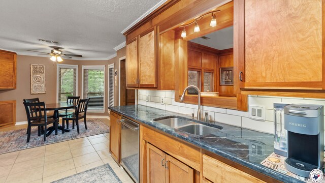 905 Lakeridge Ln, Texarkana, TX 75503 - kitchen featuring stainless steel dishwasher, a sink, dark stone countertops, a ceiling fan, and light tile patterned floors