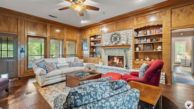 905 Lakeridge Ln, Texarkana, TX 75503 - living room with ornamental molding, wooden walls, healthy amount of natural light, ceiling fan, and wood finished floors