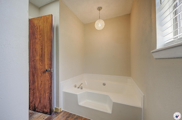 bathroom featuring a garden tub and wood finished floors