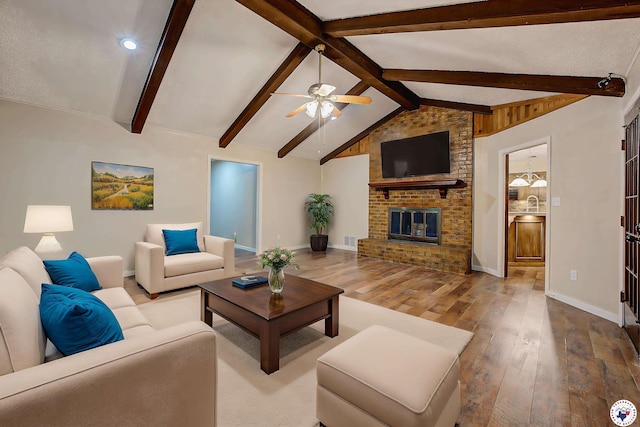 living room with a ceiling fan, hardwood / wood-style floors, lofted ceiling with beams, baseboards, and visible vents